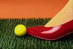 Red 616044.JPG Red shoe yellow golf ball and fake grass